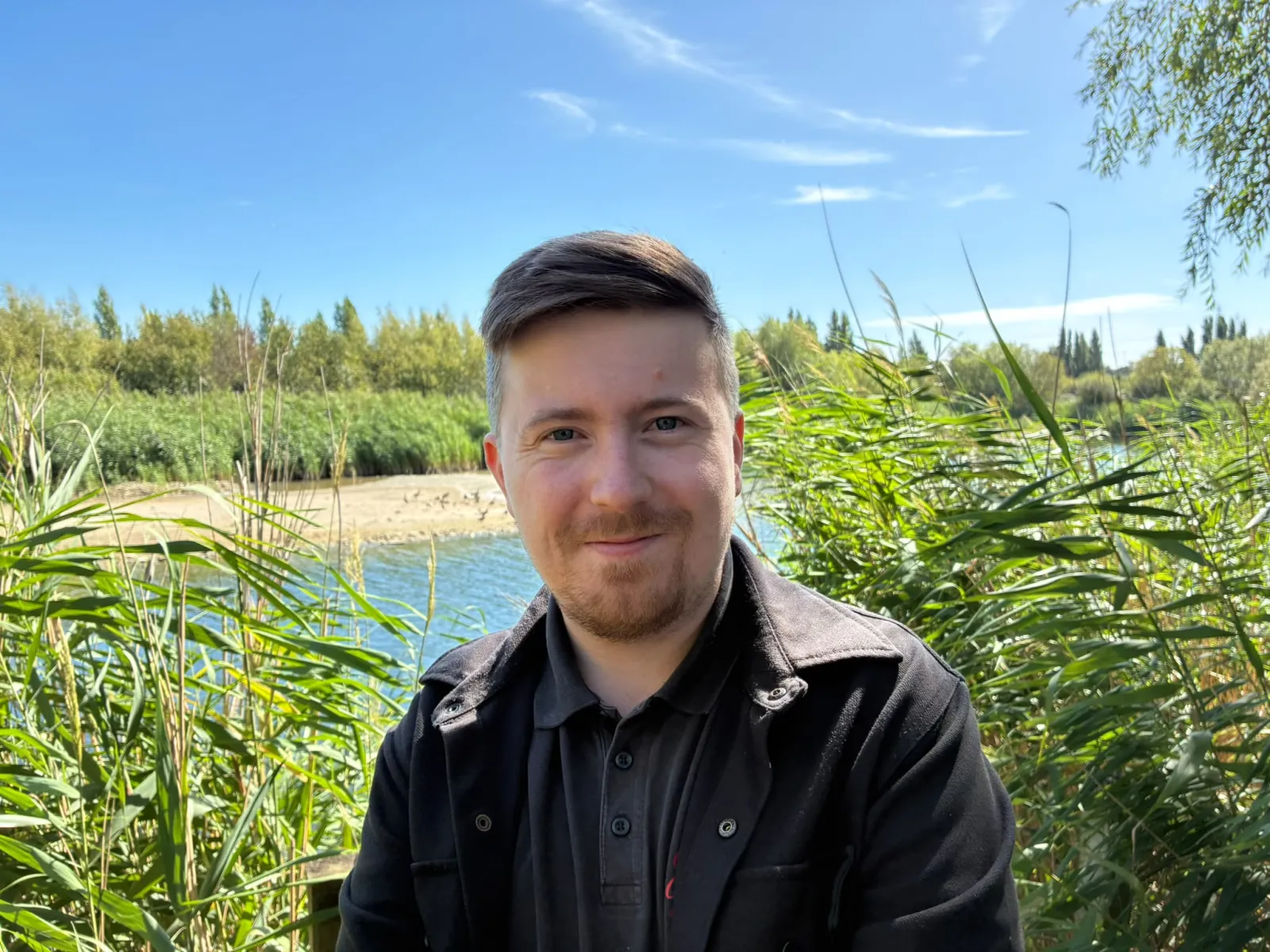 Portrait of Luke Webb beside the water